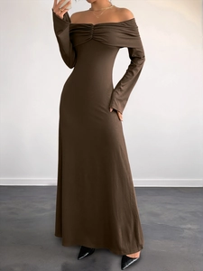 Detailed view of dark brown off-shoulder knit dress with elegant front twist knot texture