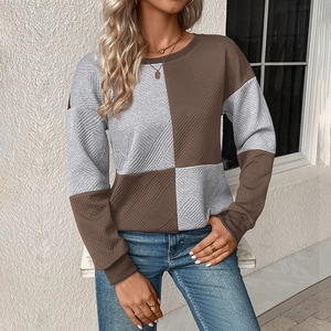 Detail of grey and brown color-block sweatshirt with diagonal weave texture fabric