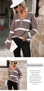 Detail of V-neck striped knit sweater with decorative buttons and soft texture