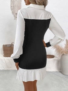 Back view of a chic black and white color-block long sleeve mini dress with pleated hem