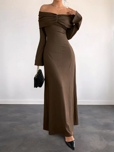 Detail of elegant off-shoulder brown maxi dress with ruching and slim fit style
