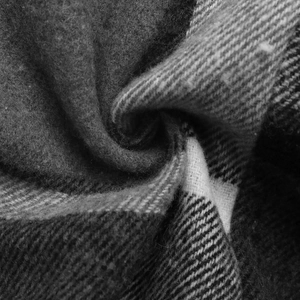 Close-up detail of soft plaid fabric with brushed texture and classic check pattern