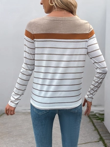 Outdoor street shot of a long-sleeved striped T-shirt with color-block shoulder detail