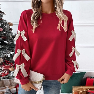 Women's red crewneck sweatshirt with bow accents on sleeves for Christmas parties