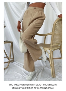 Detailed macro view of khaki corduroy wide-leg pants featuring high waist and pleats