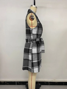 Detail of the vintage plaid vest jacket showing the classic lapel and matching waist belt