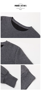 Close-up of gray textured knit pullover with ribbed cuffs and soft fleece lining