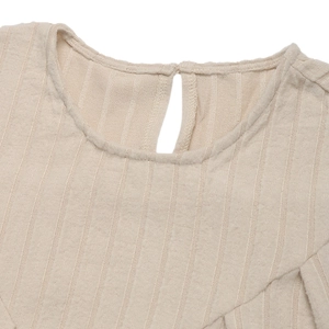 Dettaglio di un abito in maglia a coste beige con apertura a goccia sulla scollatura dietro