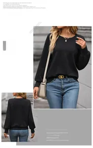 Detail of black crewneck sweatshirt with geometric textured fabric and lantern sleeves