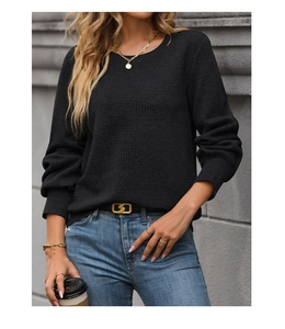 Macro shot of black long-sleeve knit sweater with unique geometric texture details