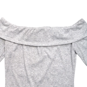 Detail of light grey marl off-shoulder top showing soft jersey knit texture and folding