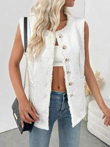 Detail of white tweed vest with gold embossed buttons and frayed edge texture on women