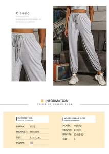 Detailed close-up of light gray high-waisted joggers with drawstring and elastic cuffs