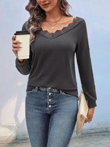 Detail view of V-neckline with black lace stitching on dark grey long sleeve top