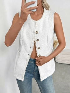 Close-up of white tweed vest featuring textured fabric and gold vintage buttons