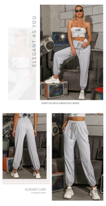 Detail view of high waisted light grey joggers with drawstring and elastic cuffs