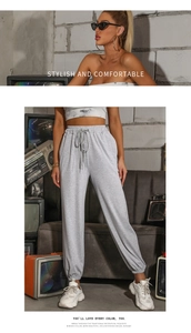 Detailed view of high-waisted grey joggers with adjustable drawstring and elastic cuffs