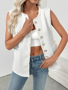 Close-up of elegant white tweed vest featuring gold buttons and fringe texture