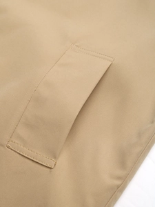 Close-up of khaki jacket pocket with high-density twill fabric and premium stitching