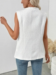 Close-up of white tweed vest texture showing frayed edges and elegant weave details