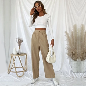 Women's white long sleeve crop top with khaki high waisted corduroy wide leg trousers