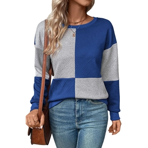 Detail view of women's color block sweatshirt featuring 3D geometric quilted texture