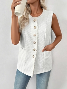 Detail of white tweed vest featuring gold embossed buttons and frayed edge texture