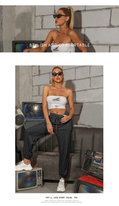 Tie-dye tube top and dark gray drawstring joggers set in a retro industrial studio