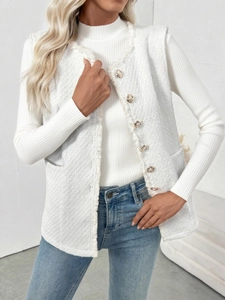 Detail of white tweed vest featuring gold buttons and fringe trim for women