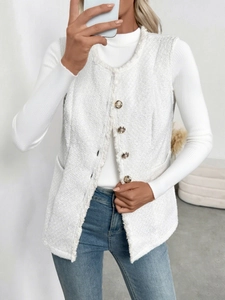 Detail of white tweed vest featuring fringed edges and decorative vintage gold buttons