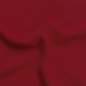 Macro shot of dark red woven fabric showing the fine plain weave texture and drapery