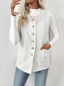 Detail of white tweed sleeveless vest with elegant golden buttons and woven texture