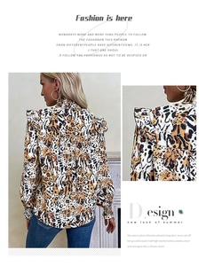 Detail of leopard print blouse featuring a high neck and ruffled shoulder accents