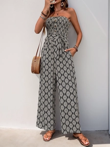 Detail of strapless wide-leg jumpsuit with geometric print and waist tie-up belt