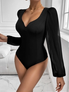 Detail of elegant black mesh bodysuit featuring sheer puff sleeves and V-neckline design