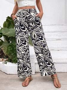 Detail of high-waisted wide-leg trousers featuring black and white paisley floral print