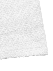 Close-up of white tweed fabric texture showing refined weaving and thick material