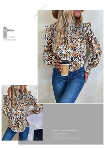 Detail of the high ruffled neckline and smocked chest on this leopard print blouse