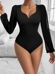 Detail view of women's black bodysuit with mesh puff sleeves and sweetheart neckline