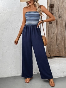 Detail of strapless summer jumpsuit with striped bodice and navy wide-leg pants