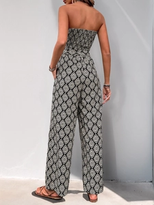 Detail of smocked bandeau jumpsuit with black and white geometric diamond print pattern