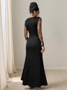 Detailed back view of black pleated maxi dress with floral mesh embroidery sleeves