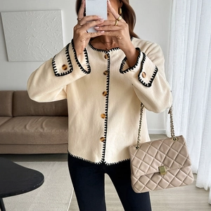 Chic beige fleece cardigan with contrast stitching and amber buttons for casual style