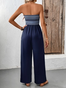 Detail of the high-waisted wide-leg trousers and blue-white striped bodice from the back