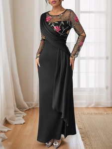 Detail of elegant black dress with floral embroidery on sheer mesh and draped pleated design