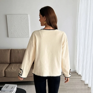 Chic cream fleece cardigan with contrast black stitching and button sleeve details