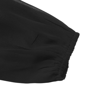 Detail of elastic cuffs on a black chiffon bodysuit featuring pleated mesh sleeves