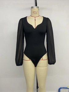 Detail of black bodysuit with mesh sheer sleeves and deep sweetheart neckline on mannequin
