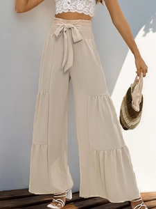 Detail of high waist apricot tiered wide leg trousers with elastic drawstring waist