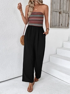 Detail view of colorful striped tube top jumpsuit with black wide leg pants and pockets